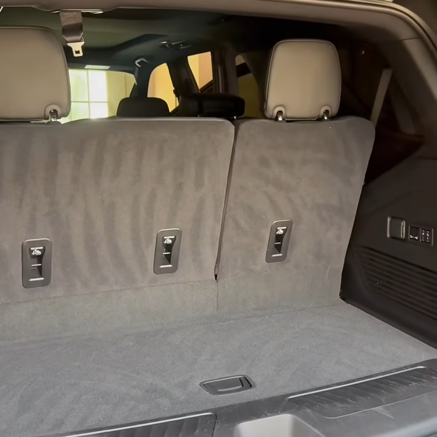 Vacuumed cargo area and folded rear seats of a Chevrolet Tahoe